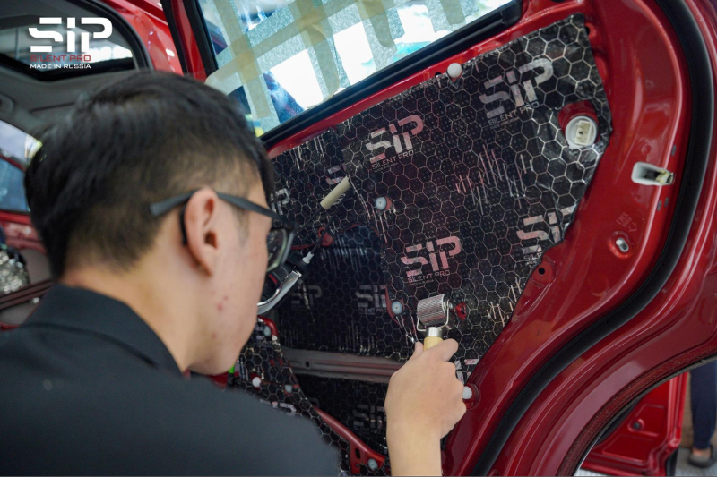 Kỹ thuật viên thi công dán cách âm SIP cho xe hơi